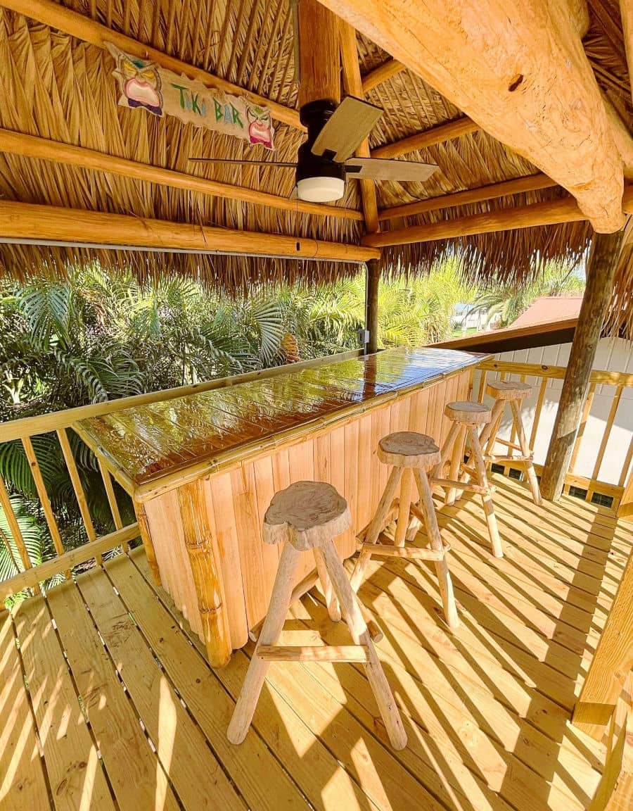 Tiki bar built 10 feet off the ground.  Wooden bar and wooden stools.